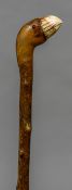 A late 19th/early 20th century novelty walking stick The ivory mounted handle formed as a parrot.