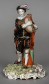 A Continental porcelain figure of a piper Modelled standing before a drum,