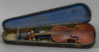 A 19th/20th century violin Of typical form, with lion mask carved scroll, cased. 60 cm long.