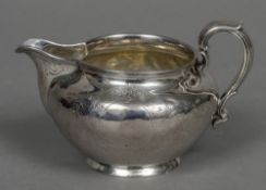 A Victorian silver cream jug, hallmarked London 1865,