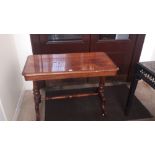 A Victorian walnut centre table The rounded rectangular top supported on turned uprights united