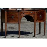 A George III mahogany sideboard The crossbanded and line inlaid shaped top above a central drawer