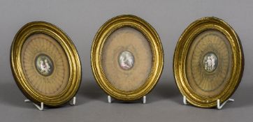 Three framed enamel plaques, possibly 18th century Each depicting two putto with a pet,