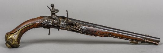 An 18th/19th century flintlock pistol The long barrel with incised decoration,