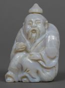 A Chinese carved opalescent stone snuff bottle Formed as a bearded figure. 5.5 cm high.