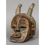 An African wooden tribal mask Probably formed as the devil. 30 cm high.