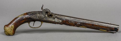An 18th/19th century percussion pistol The long barrel with white metal inlaid decoration,