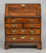 An 18th century bureau, possibly fruitwood The top inset with two named brass coin slots,