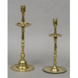 A 17th century Dutch brass candlestick Together with another, 18th century.
