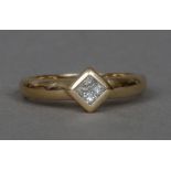 A 9 ct gold diamond ring Set with four princess cut diamonds.