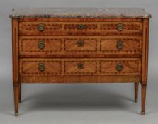 A Louis XVI style marble topped commode The shaped rectangular variegated marble top above an