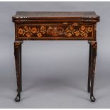 A late 18th/early 19th century Dutch marquetry card table The shaped hinged rectangular top inlaid