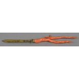 A 19th century coral mounted unmarked gilt metal paper knife The engraved handle with an acanthus