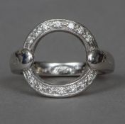 An 18 ct white gold diamond set ring designed by Asanti Of circular form the shank inscribed twice