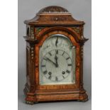 A Victorian walnut cased eight day striking bracket clock The silvered 6" arched dial with Roman