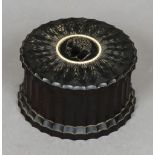 A George IV turned ebony box and cover Of fluted cylindrical form,