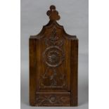 A 19th century candle box With twin trefoil finials above the carved sliding panel. 47.5 cm high.