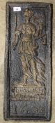 A cast iron plaque depicting justice