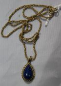 A lapis lazuli pendant on a 9 ct gold chain