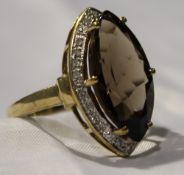 A diamond and smokey quartz ring