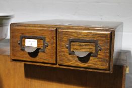 A pair of oak filing drawers