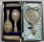 A cased silver backed dressing table set