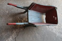 A vintage child's wooden wheel barrow