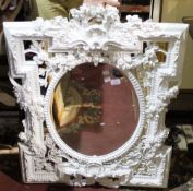 An ornate white framed mirror