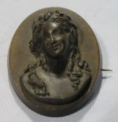 A brooch decorated with a female bust