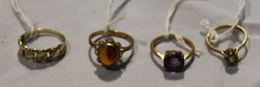 Four 9 ct gold rings with various stones and settings