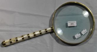 A large mother-of-pearl magnifying glass