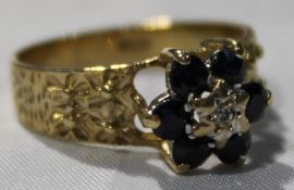 A diamond and sapphire flower head ring