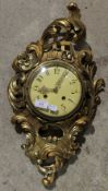 A gilt wooden cartel clock