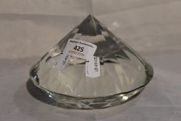 A paperweight in the shape of a large diamond