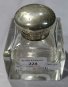 A silver topped glass inkwell