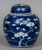 A 19th century Chinese ginger jar and cover, decorated in blue and white with prunus blossoms,