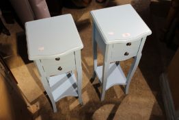 A pair of blue painted bedside tables