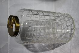 A tall cut glass lidded jar