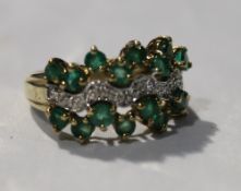 A 9 ct gold diamond and emerald ring