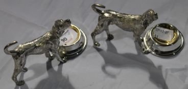 A pair of silver plated dog salts
