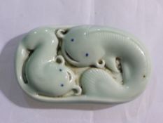 A porcelain dolphin paperweight