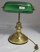 A desk light with a green shade