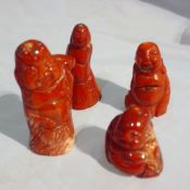 Four carved coral figures