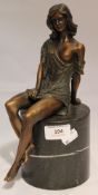 A bronze formed as a semi nude girl