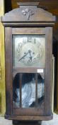 An oak cased wall clock