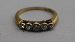 A gold five stone diamond ring