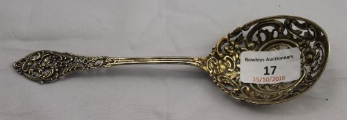 A silver sifting spoon