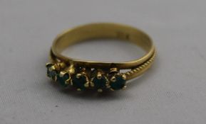 A gold and emerald ring