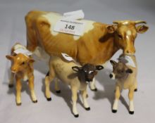 A Beswick cow and three calves