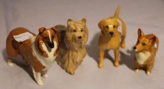 Four Beswick dogs